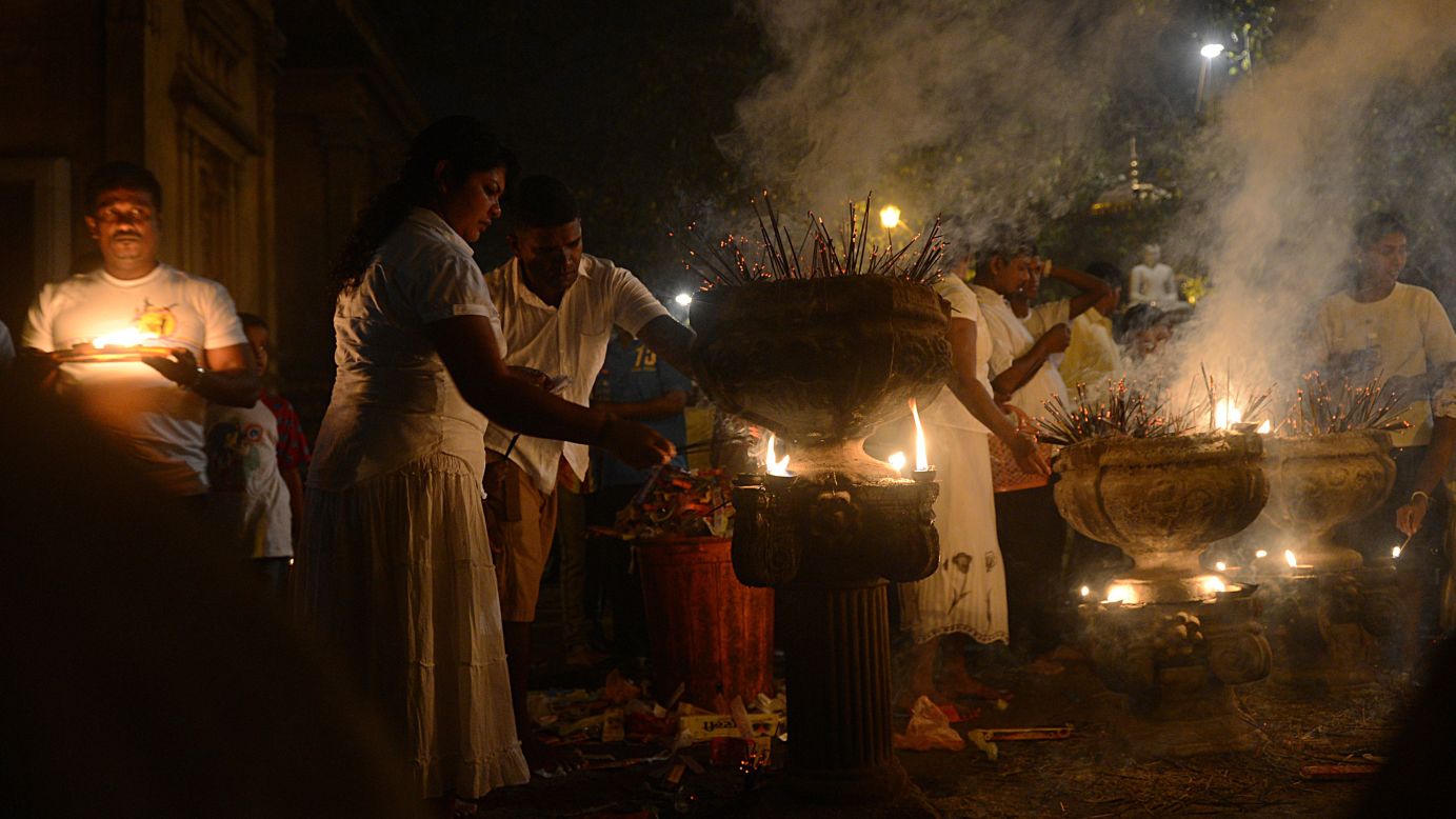 Sri Lankan Buddhists light incense sticks as they offer prayers at the Kelaniya Temple in Kelaniya. Many marked the beginning of 2013 with religious ceremonies.
