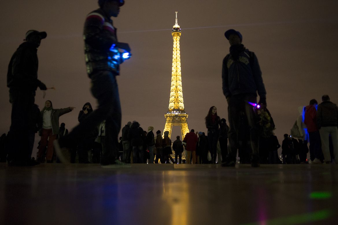 People gather as they celebrate the arrival of 2013 on Trocadero Square beside the Eiffel Tower in Paris.