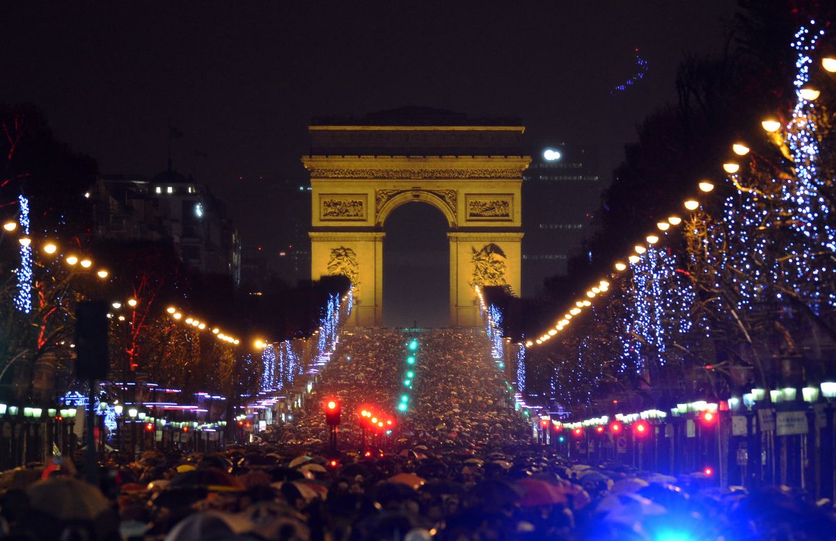 People gather on Champs-Elysees Avenue in Paris to mark the beginning of 2013.