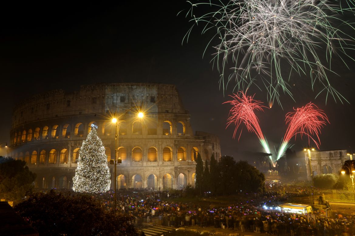 Fireworks light up the ancient Colosseum in central Rome's Via dei Fori just after midnight on January 1.