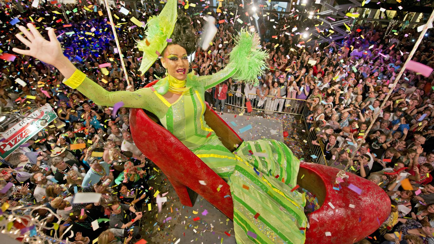 Gary Marion, portraying female impersonator Sushi, hangs in an oversized replica of a women's red high heel over Duval Street in Key West, Florida. The Red Shoe Drop has become a Key West tradition.
