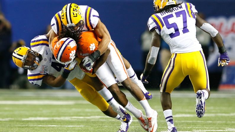 Kevin Minter, left, and Eric Reid, top middle, tackle DeAndre Hopkins of the Clemson Tigers during the Chick-fil-A Bowl at the Georgia Dome on Monday, December 31, 2012 in Atlanta.