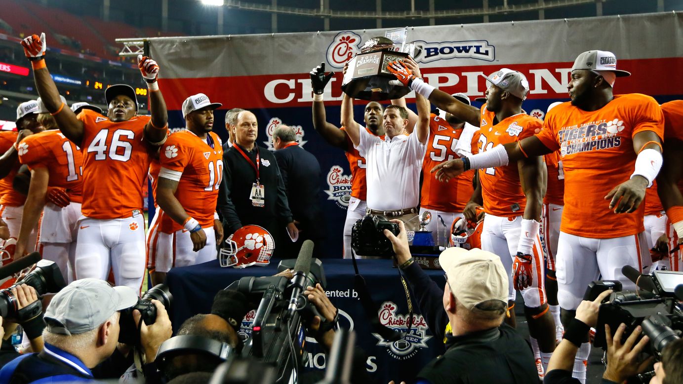 Head coach Dabo Swinney and his Clemson Tigers celebrate their 25-24 win over the LSU Tigers during the Chick-fil-A Bowl on December 31.