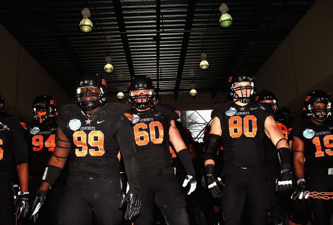 The Oklahoma State Cowboys walk to the field before taking on the Purdue Boilermakers in the Heart of Dallas Bowl in Cotton Bowl Stadium on Tuesday, January 1, in Dallas, Texas.