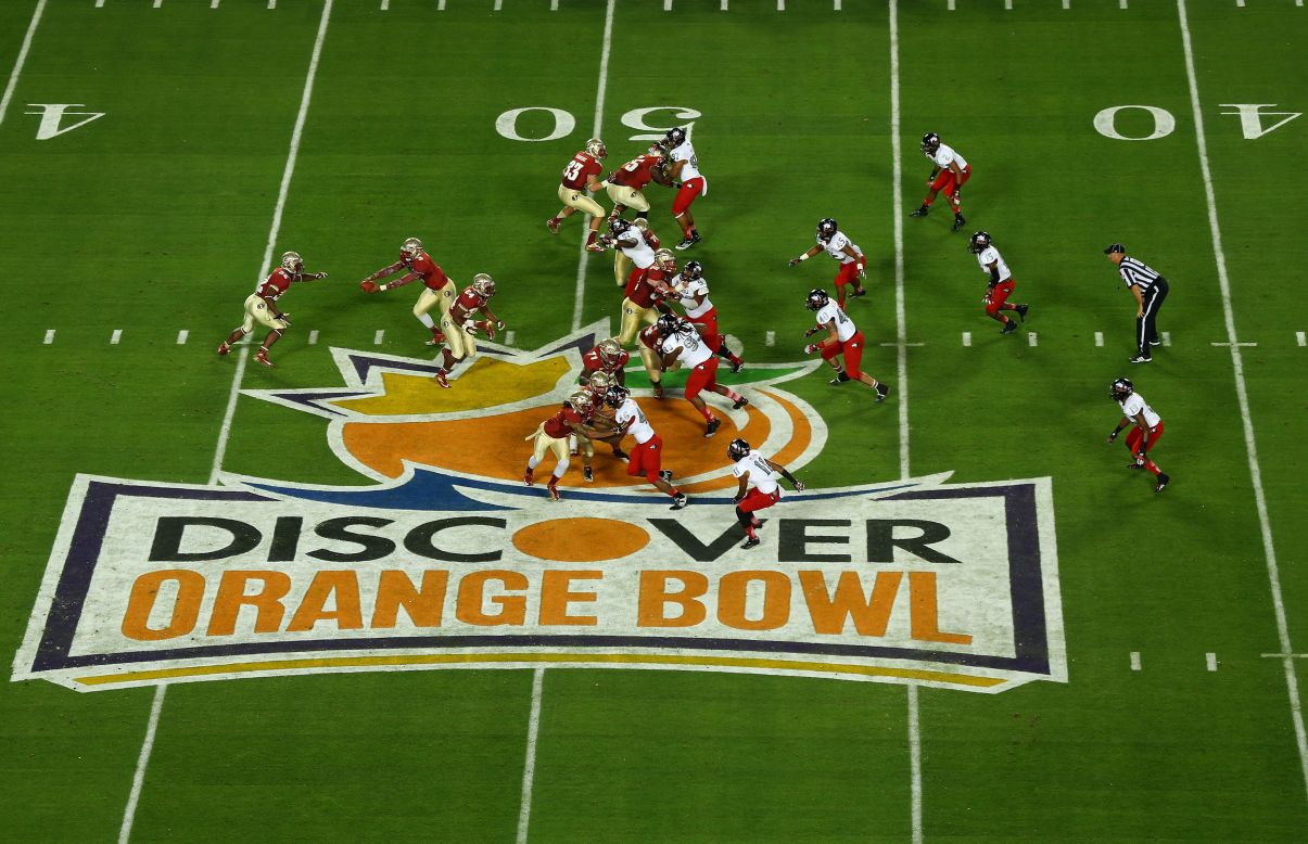 Quarterback EJ Manuel of the Florida State Seminoles makes a hand-off in the first quarter against the Northern Illinois Huskies during the Discover Orange Bowl at Sun Life Stadium on Tuesday, January 1, in Miami Gardens, Florida.