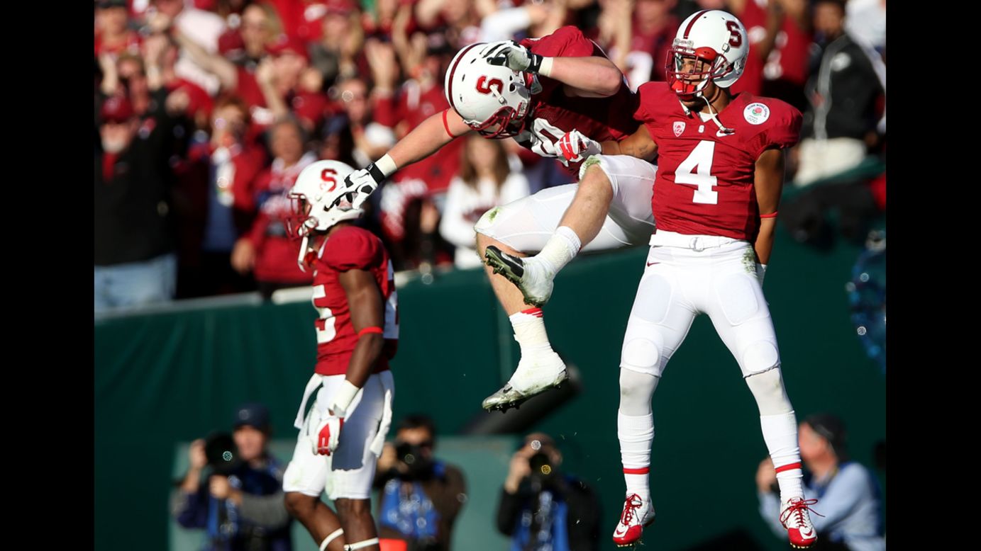 Josh Mauro and Blake Martinez of the Stanford Cardinal celebrate after stopping the Wisconsin Badgers on a fourth down in the first half on January 1.