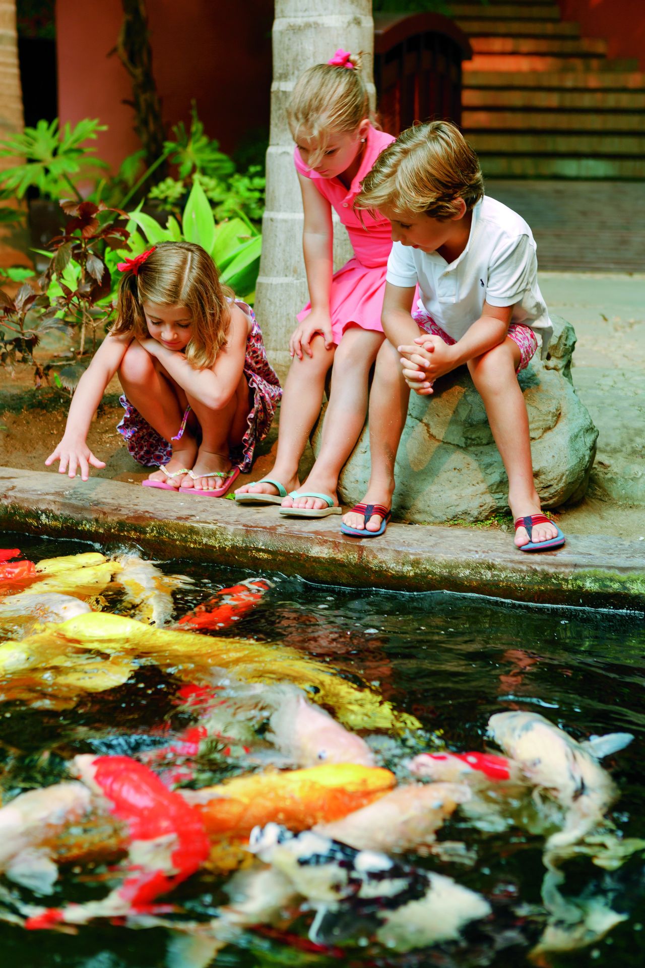 Children at the Koi Carp pond at the Abama Golf and Spa Resort.