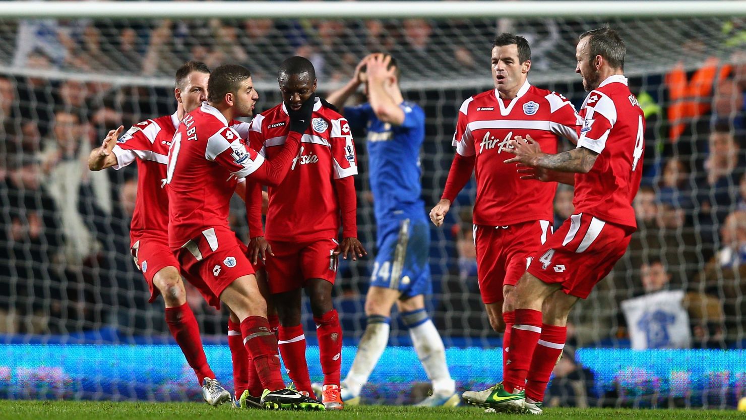 QPR players celebrate following Shaun Wright-Phillips' 78th minute winner at Chelsea.