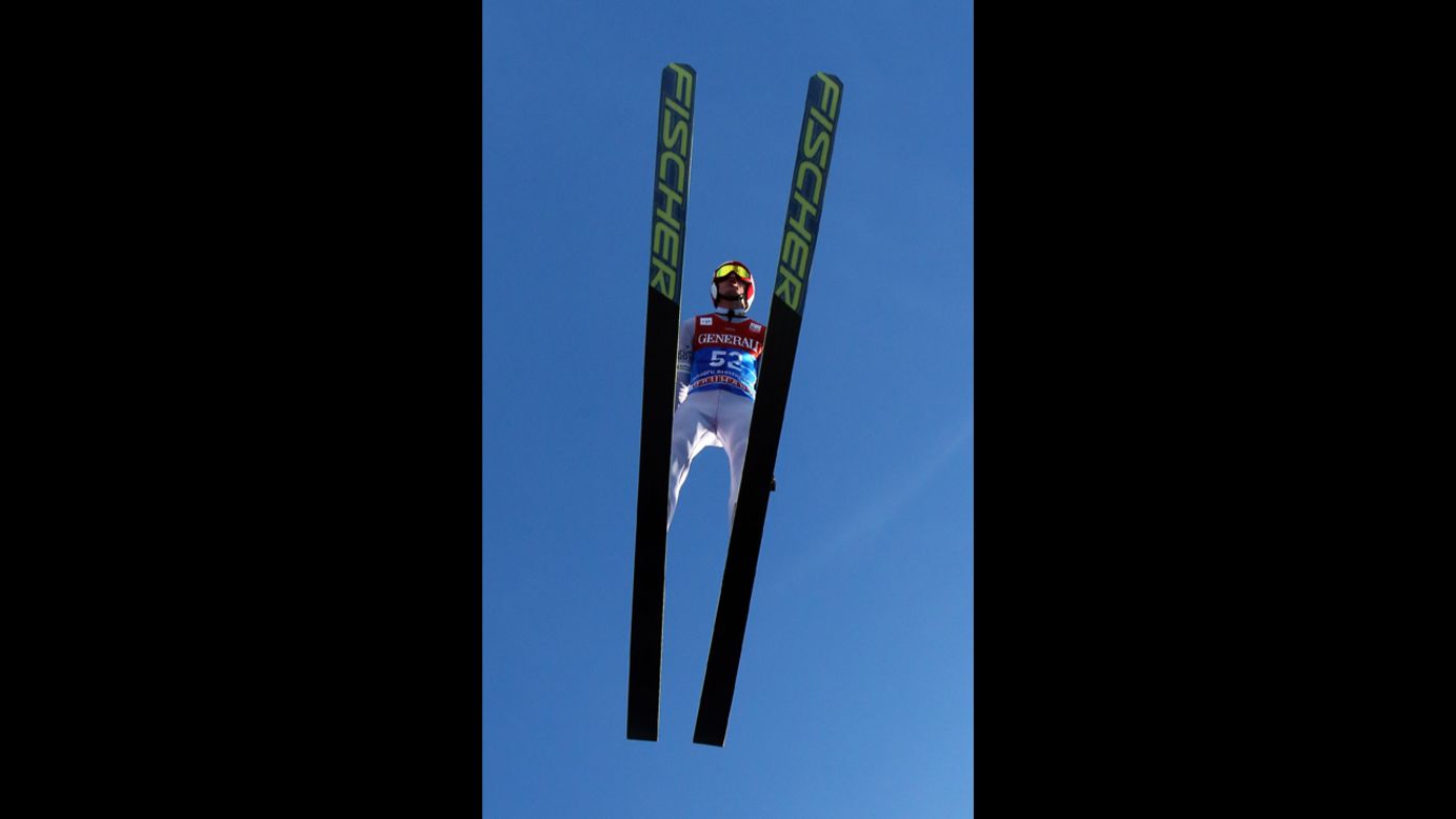 Kamil Stoch of Poland flies through a blue sky on Monday, December 31, in Garmisch-Partenkirchen, Germany.