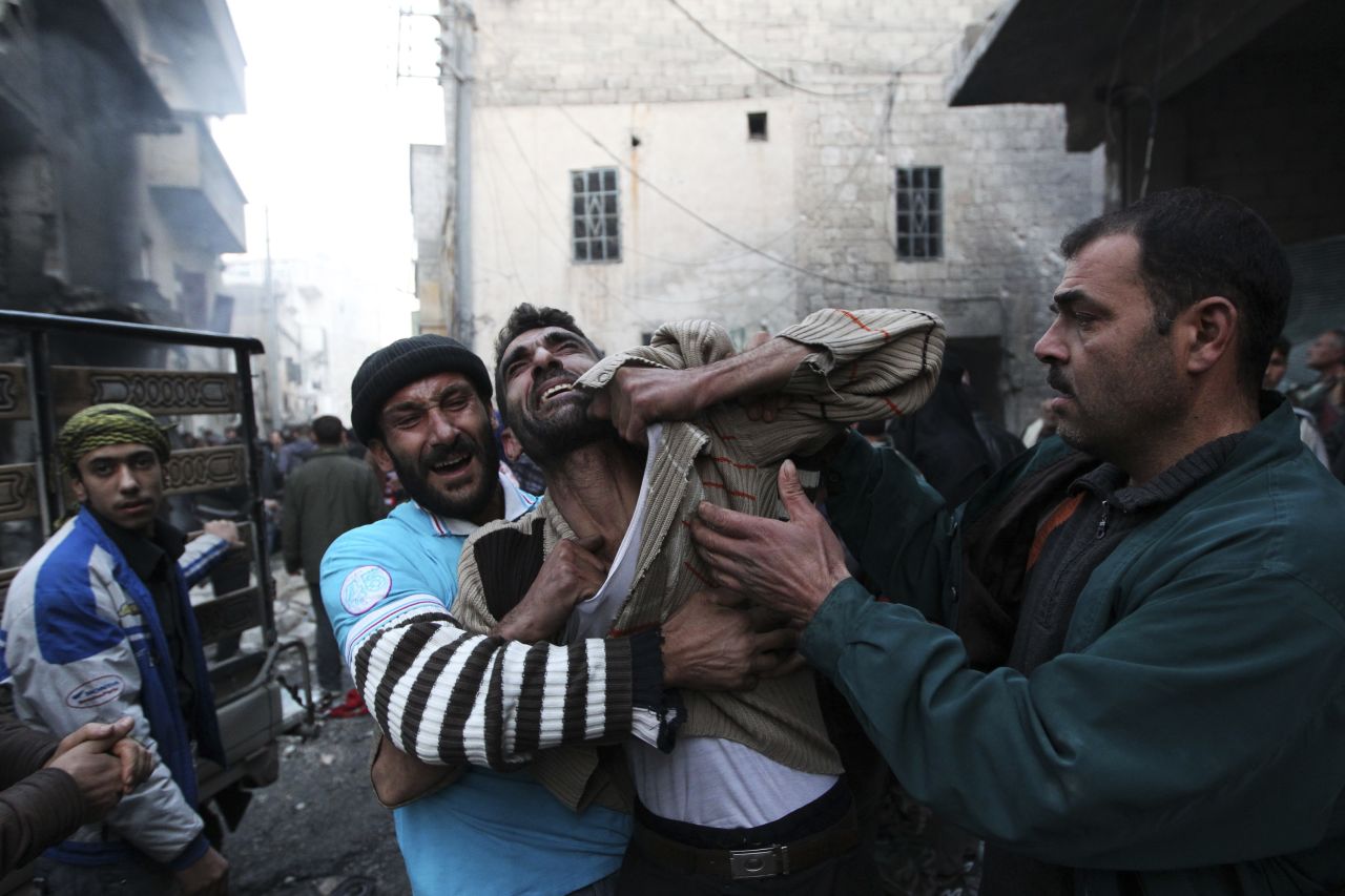 A father reacts after hearing of a shelling by forces loyal to Syria's President Bashar al-Assad in Aleppo on January 3.