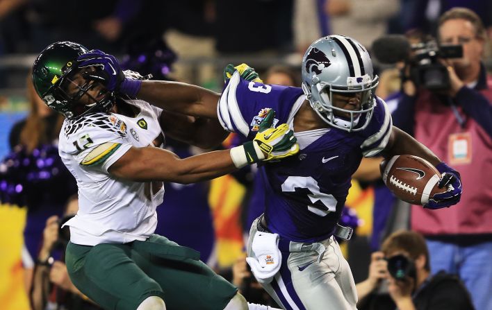 Brian Jackson of the Oregon Ducks tries to tackle Chris Harper of the Kansas State Wildcats during the Tostitos Fiesta Bowl on January 3.