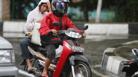 An Acehnese woman rides on the back of a motorcycle in Banda Aceh on January 2. 