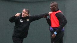 Manchester City manager Roberto Mancini was photographed grappling with his firebrand striker Mario Balotelli during a training run on Thursday, prompting coaching staff to intervene to separate the pair. Mancini later downplayed the tussle, sparked by Balotelli's hostile tackle on a fellow player, as "nothing unusual."