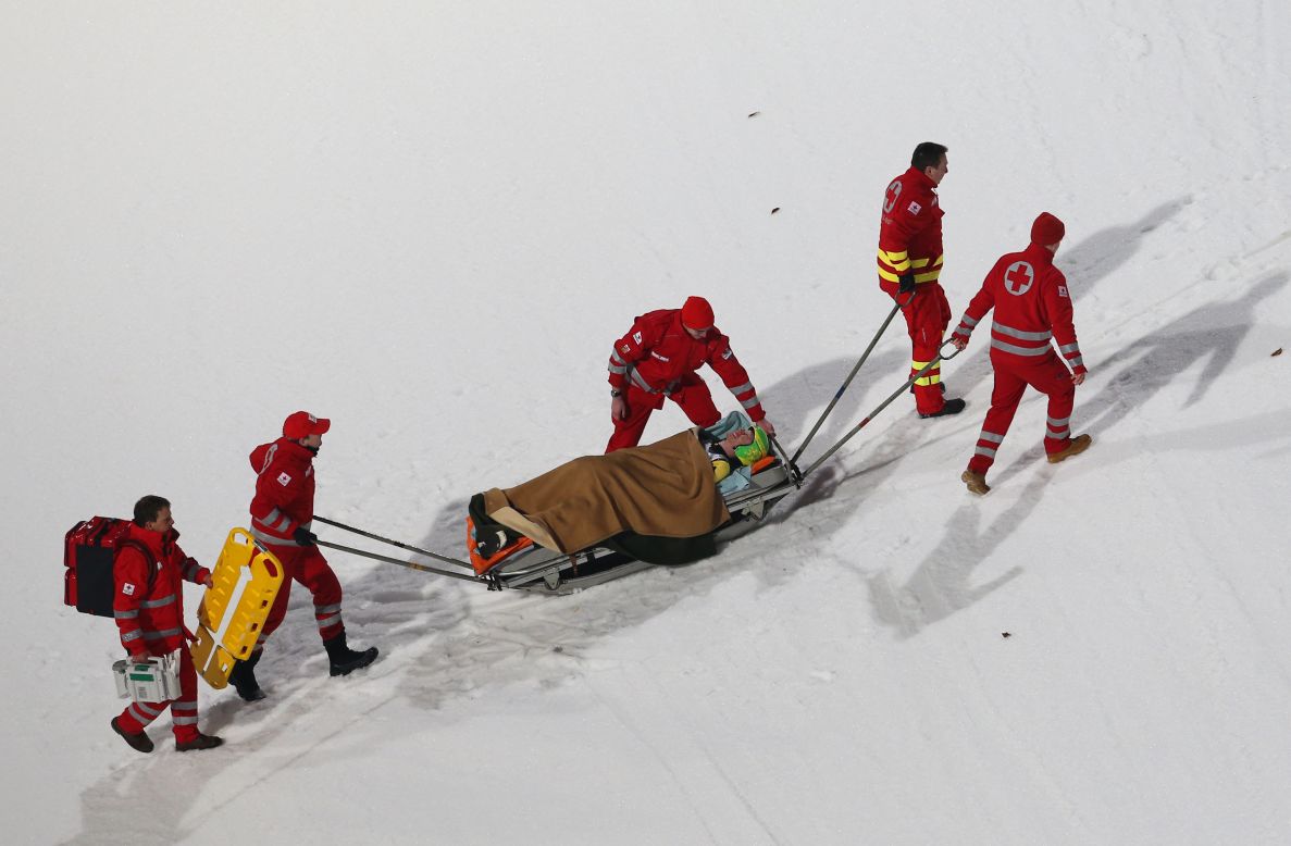 Medical staffers carry Russia's Denis Kornilov during a practice session on January 5.