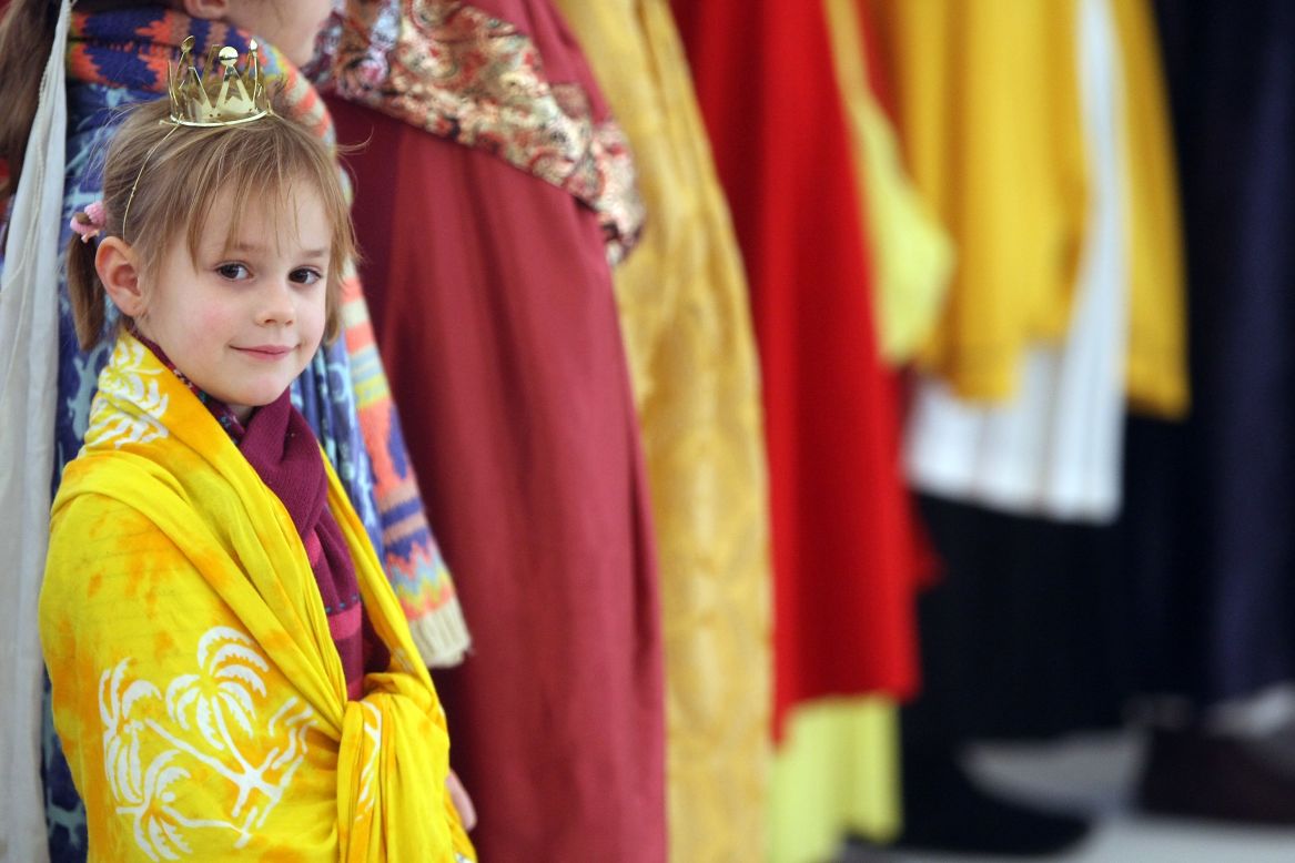 A child dressed as one of the Magi waits to greet Gauck at the Bellevue presidential palace on Sunday in Berlin.