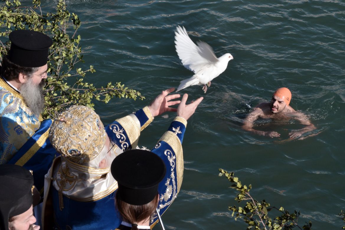 A priest releases a dove during the blessing of the waters during Epiphany celebrations in the city of Volos, Greece, on Sunday.