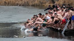 People dive into icy water as they compete to grab a cross in the middle of a lake as part of Epiphany celebrations on Sunday, January 6, in Sofia, Bulgaria. It is believed that the first person to grab the cross, thrown into the water by an Eastern Orthodox priest, will be healthy throughout the following year. The feast day celebrates the revelation of God in human form as Jesus Christ. 