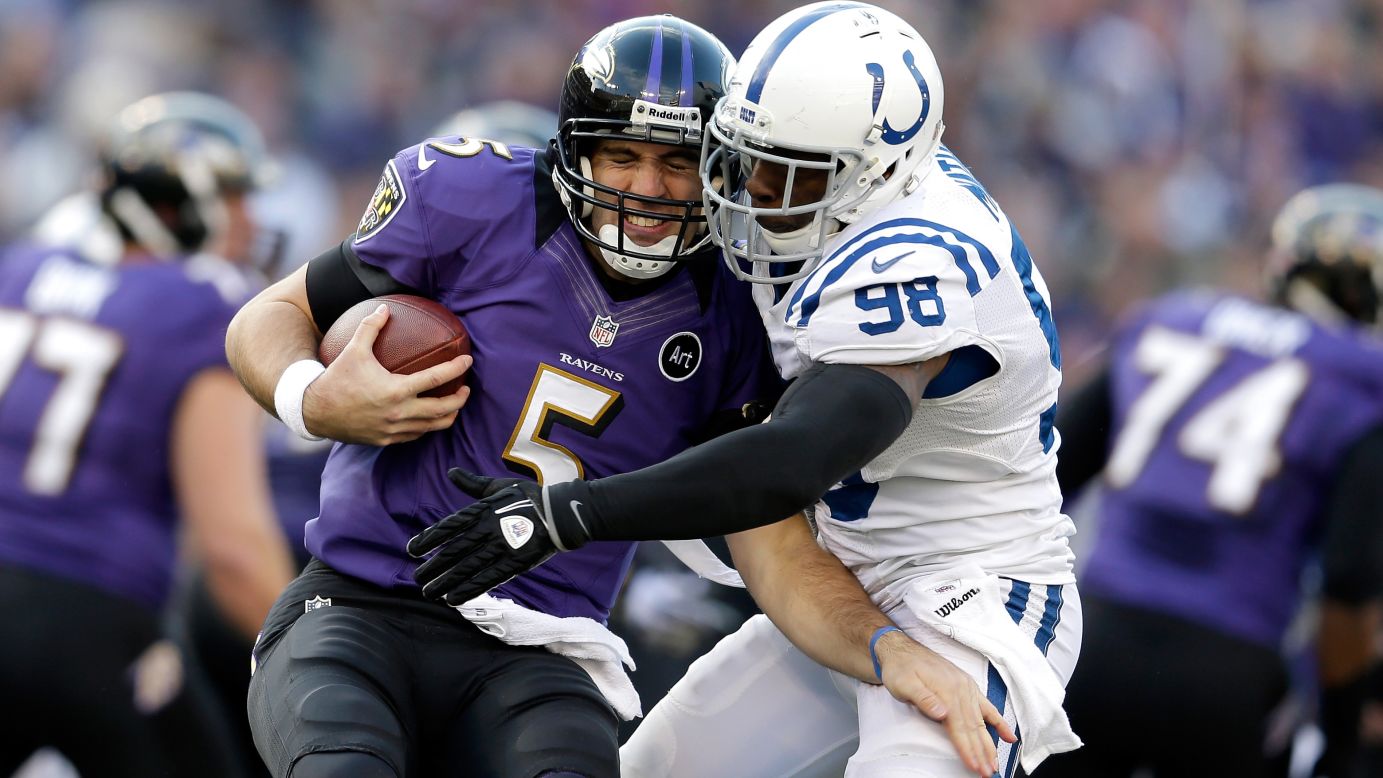 Joe Flacco of the Baltimore Ravens is sacked by Robert Mathis of the Indianapolis Colts on Sunday.