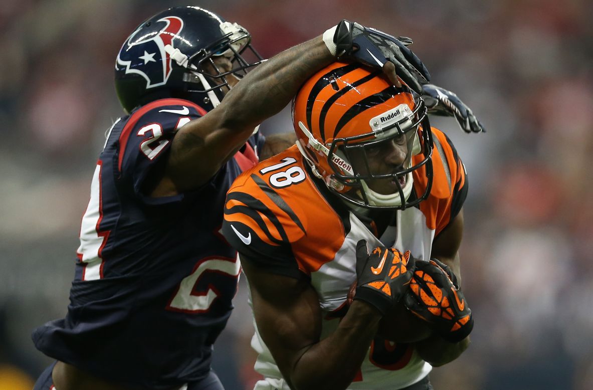 A.J. Green of the Bengals catches the ball as Houston's Johnathan Joseph goes for the tackle.