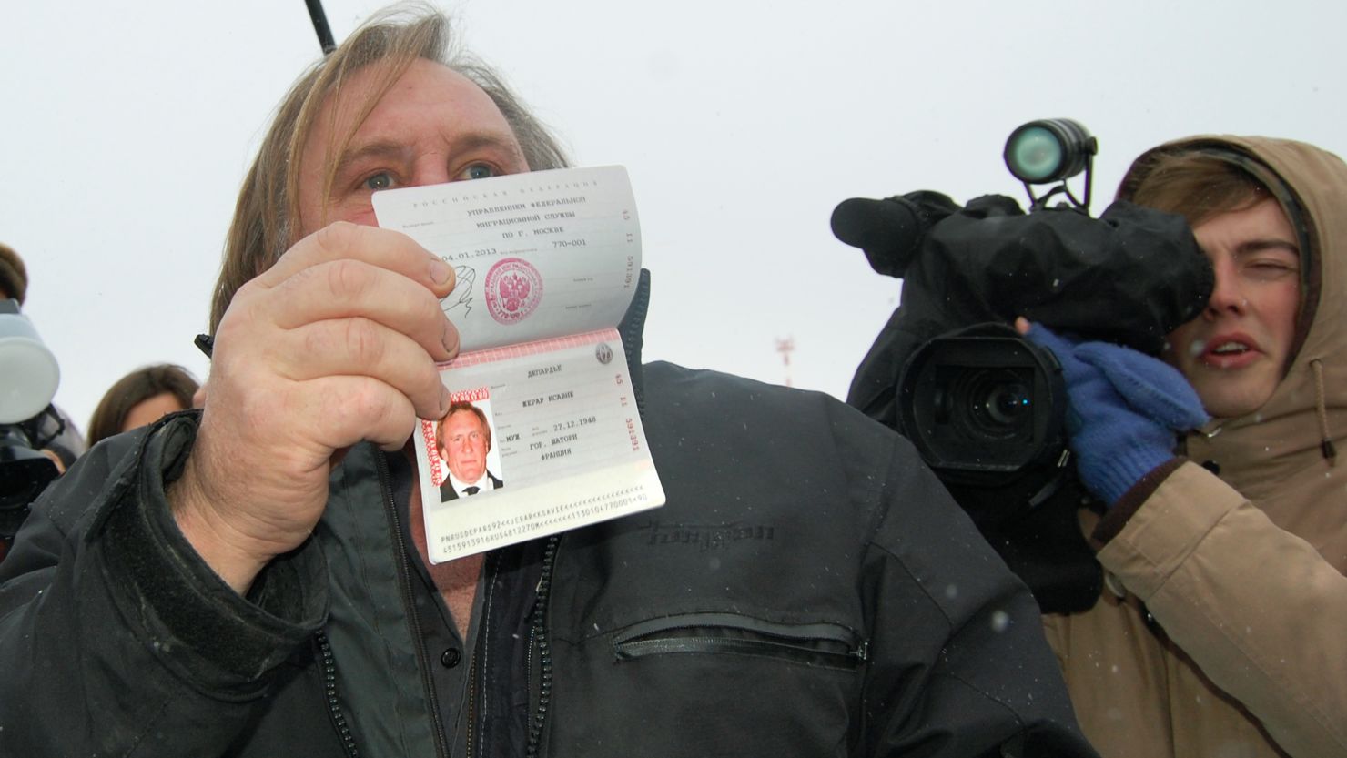 French actor Gerard Depardieu shows off his new Russian passport on January 6, 2013.