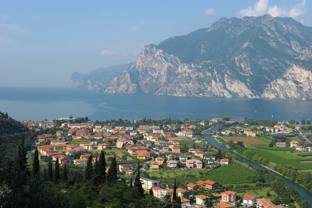 The picturesque town of Nago Torbole basks in the summer sunshine on the banks of Lake Garda.   