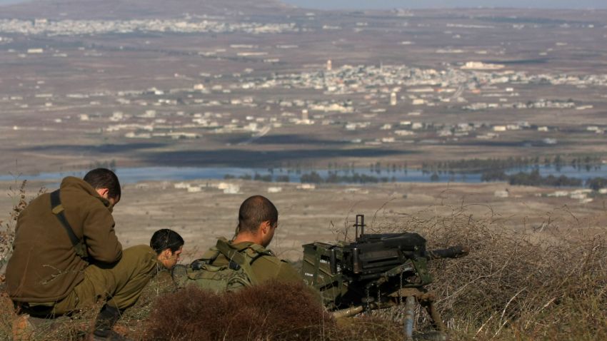 (File photo) Israeli soldiers stands in an abandoned military outpost overlooking the ceasefire line between Israel and Syria on Tal Hazika near Alonei Habshan in the Israeli-occupied Golan Heights on November 15, 2012.