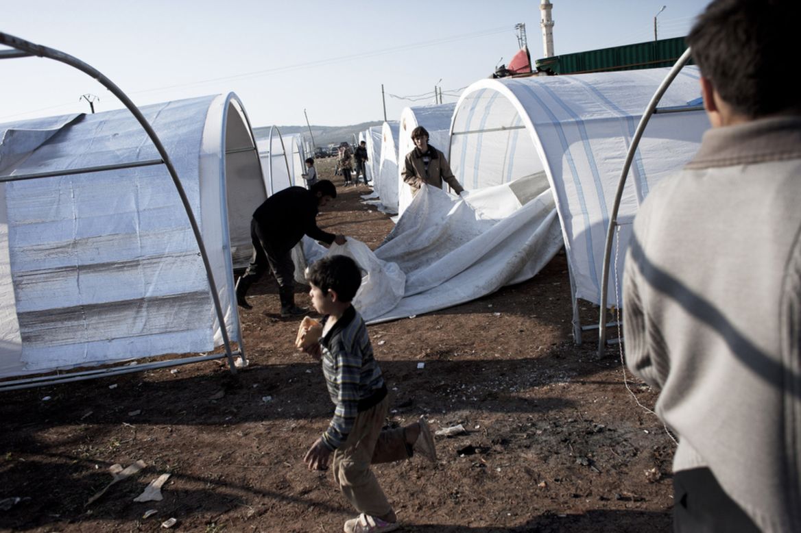 A Syrian family erects their tent at the Bab al-Salam refugee camp January 1.
