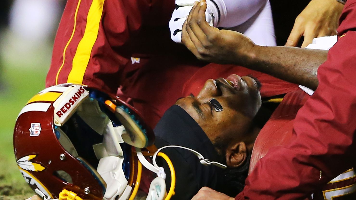 The Washington Redskins' Robert Griffin III lies injured in the fourth quarter against the Seahawks. 