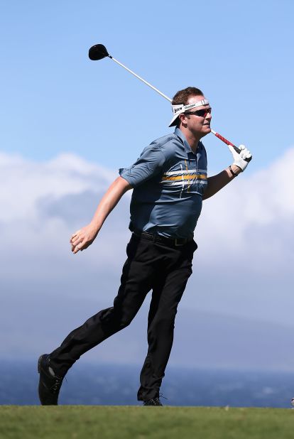 Charlie Beljan leans into the wind after taking a rehit on a tee shot on Sunday, when play was called off for the third day in a row in the PGA Tour's season-opening event. 