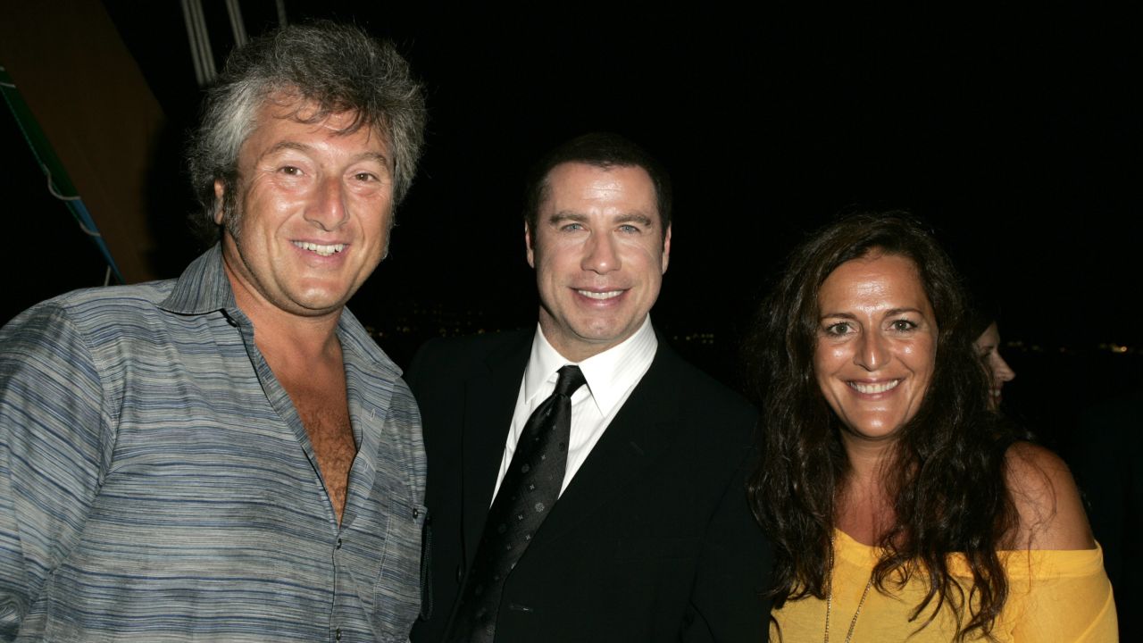 Vittorio Missoni and his sister, Angela, pose with actor John Travolta at the Venice Film Festival in 2004.