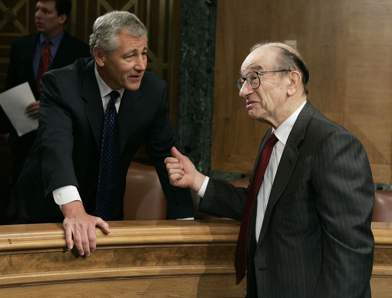 Hagel chats with Alan Greenspan, then-Federal Reserve chairman, before the start of a Senate Banking, Housing and Urban Affairs Committee hearing in April 2005.