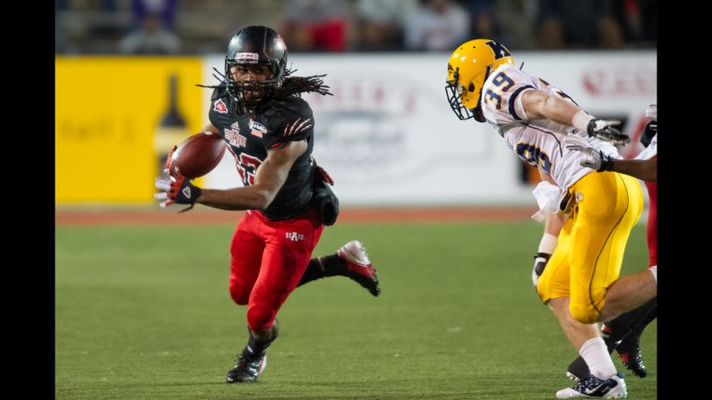 Arkansas State wide receiver J.D. McKissic eyes a run past Kent State safety Luke Wollet on Sunday, January 6,  at Ladd-Peebles Stadium in Mobile, Alabama. Arkansas State defeated Kent State 17-13 in the GoDaddy.com Bowl.