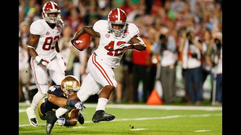 Alabama running back Eddie Lacy runs for the first touchdown of the title game against Notre Dame.