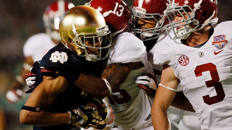 TJ Jones of Notre Dame is tackled by Alabama's Ty Reed.