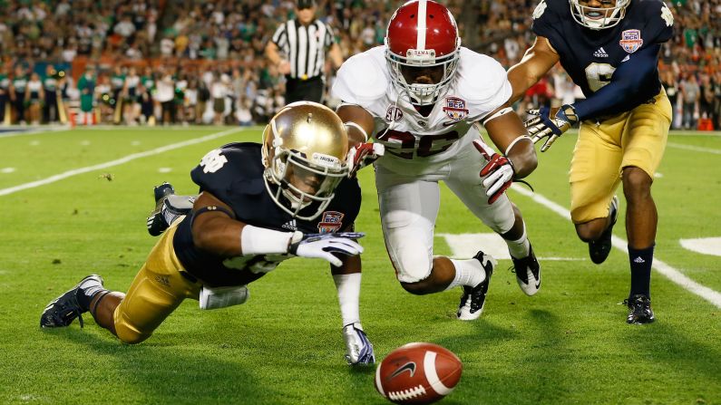 Davonte Neal of Notre Dame, left, fights Landon Collins of Alabama for a loose ball after muffing the punt in the second quarter.