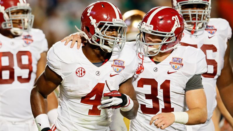 T.J. Yeldon, left, of Alabama celebrates a touchdown with teammate Kelly Johnson.