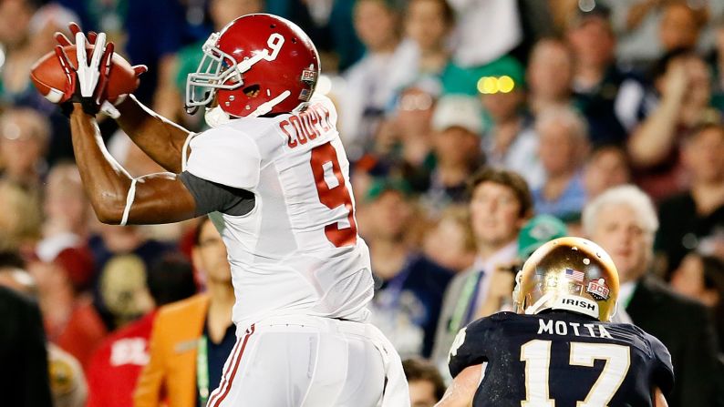 Amari Cooper of Alabama hauls in a pass in front of Zeke Motta of Notre Dame.