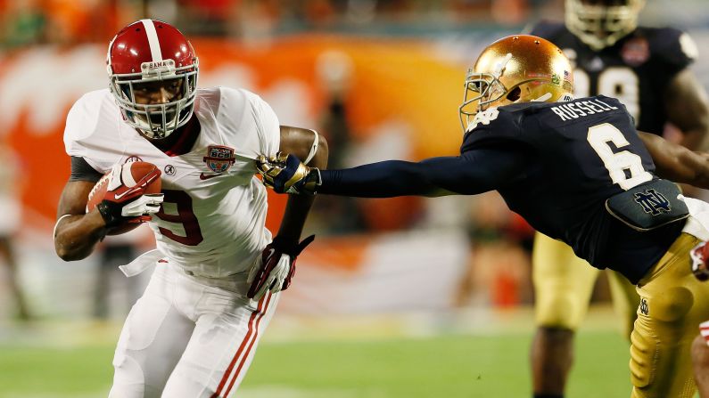 Alabama's Amari Cooper runs the ball against KeiVarae Russell of Notre Dame.