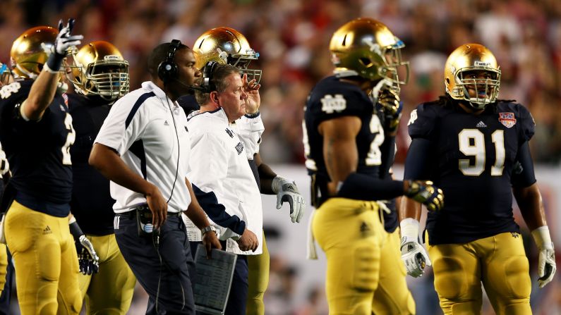 Notre Dame head coach Jim Kelly looks on from the sidelines.