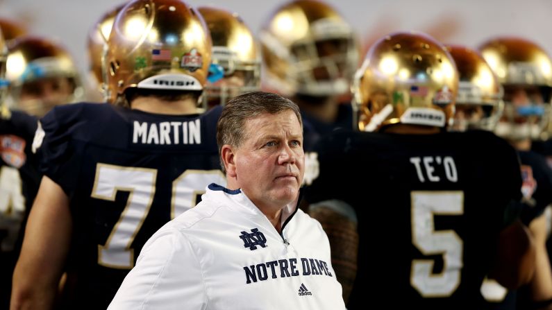 Notre Dame head coach Jim Kelly watches the game from the sidelines.