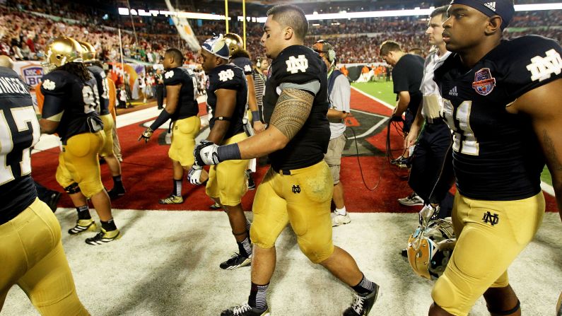 Notre Dame's Manti Te'o, center, and his teammates walk off the field at halftime. Alabama led 28-0 at the half.