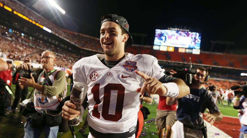 Quarterback AJ McCarron of the Alabama Crimson Tide celebrates his team's win over the Notre Dame Fighting Irish on Monday, January 7. Alabama defeated Notre Dame 42-14 in the 2013 BCS National Championship game at Sun Life Stadium in Miami Gardens, Florida. <a href="index.php?page=&url=http%3A%2F%2Fwww.cnn.com%2F2012%2F12%2F31%2Ffootball%2Fgallery%2Fcollege-bowls%2Findex.html">View the best photos from the college football bowl games.</a>