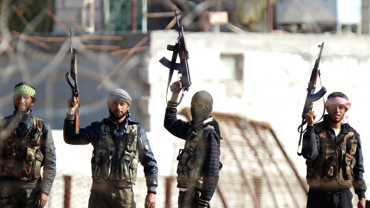 Syrian opposition fighters celebrating on the strategic Syrian border town of Ras al-Ain, on November 15, 2012.