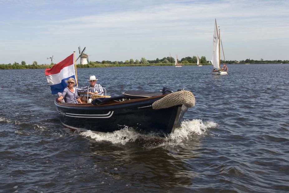 A couple set sail on Lake Kaag, the Netherlands. Boat races and regattas are a common site here in the summer months.