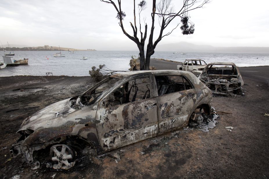 Burned out cars lie abandoned at the jetty on the Tasman Peninsula in Boomer Bay, Tasmania, on Tuesday.