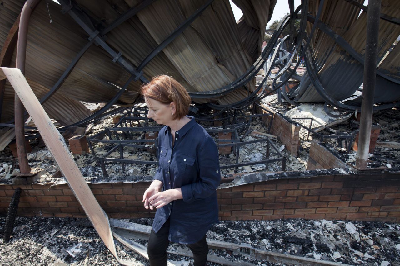 Australian Prime Minister Julia Gillard inspects the destroyed remains of the Dunalley school in southeast Tasmania, Australia, on Monday, January 7.