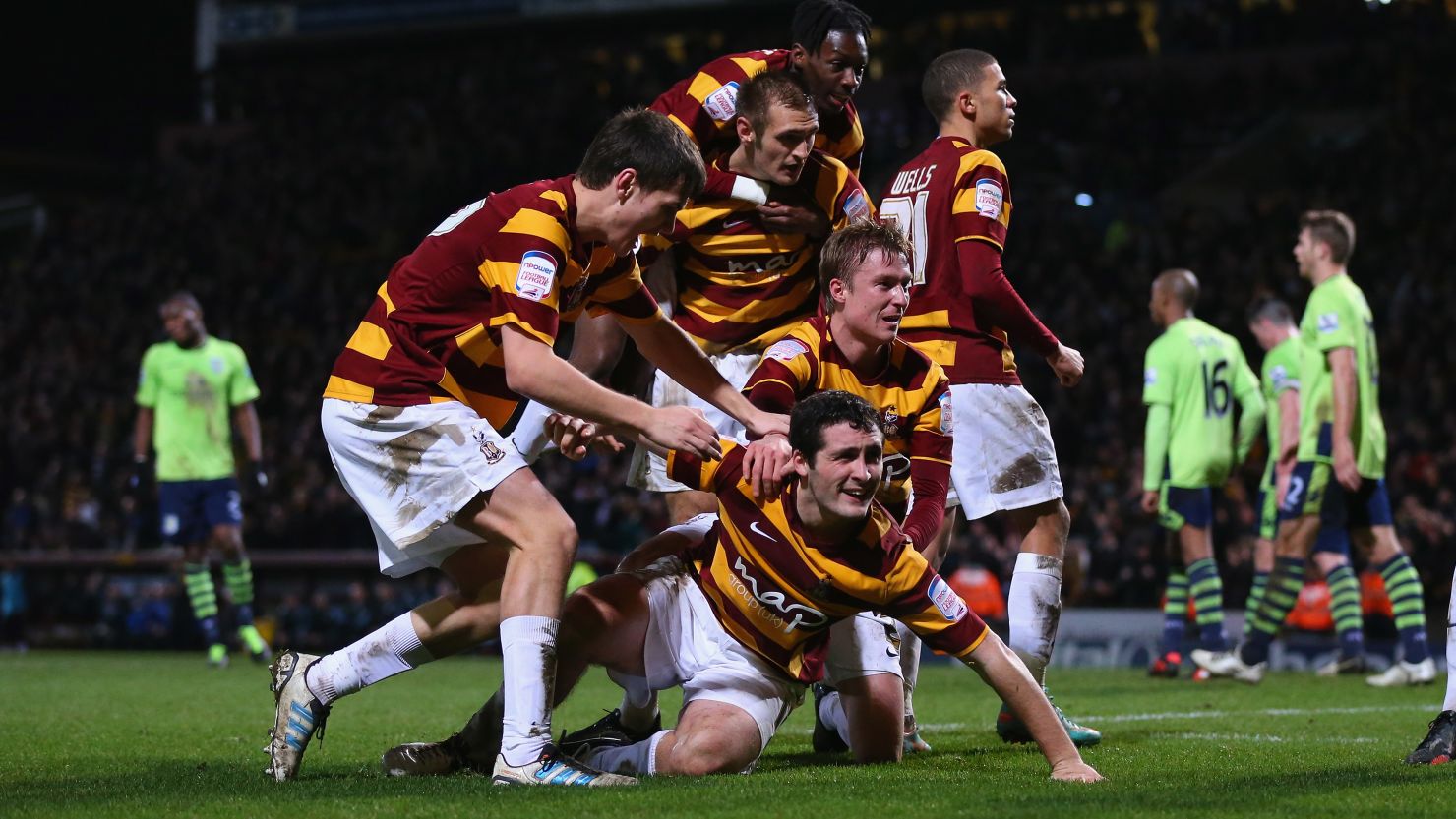 Bradford's players celebrate after Carl McHugh (grounded) scores their third against Aston Villa