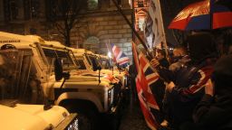 Loyalist protesters confront police as they gather at Belfast City Hall during a City Council meeting in Belfast, Northern Ireland, on Monday, January 7. Violence flared for the fifth consecutive night in Northern Ireland as pro-British demonstrators protested the council's decision to limit the number of days the British Union Jack flag can be flown above the City Hall.