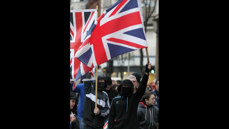 Protesters carry Union Jacks outside the City Hall on Saturday.