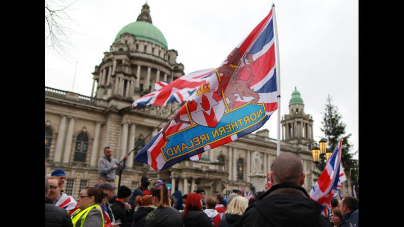 Loyalists holding British union flags march outside City Hall on Saturday.